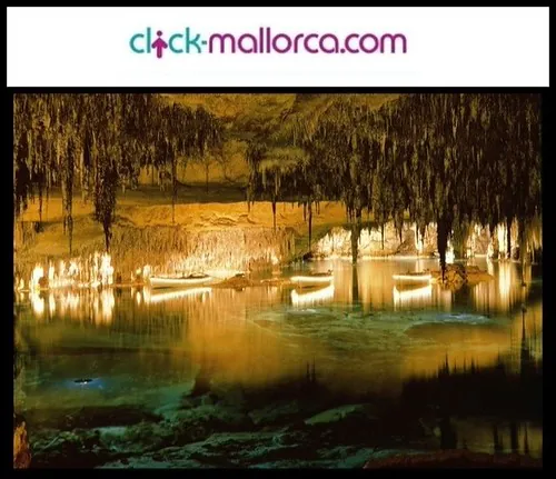 Subterranean limestone cavern with stalactites reflecting over the calm waters of Lake Martel in Cuevas del Drach