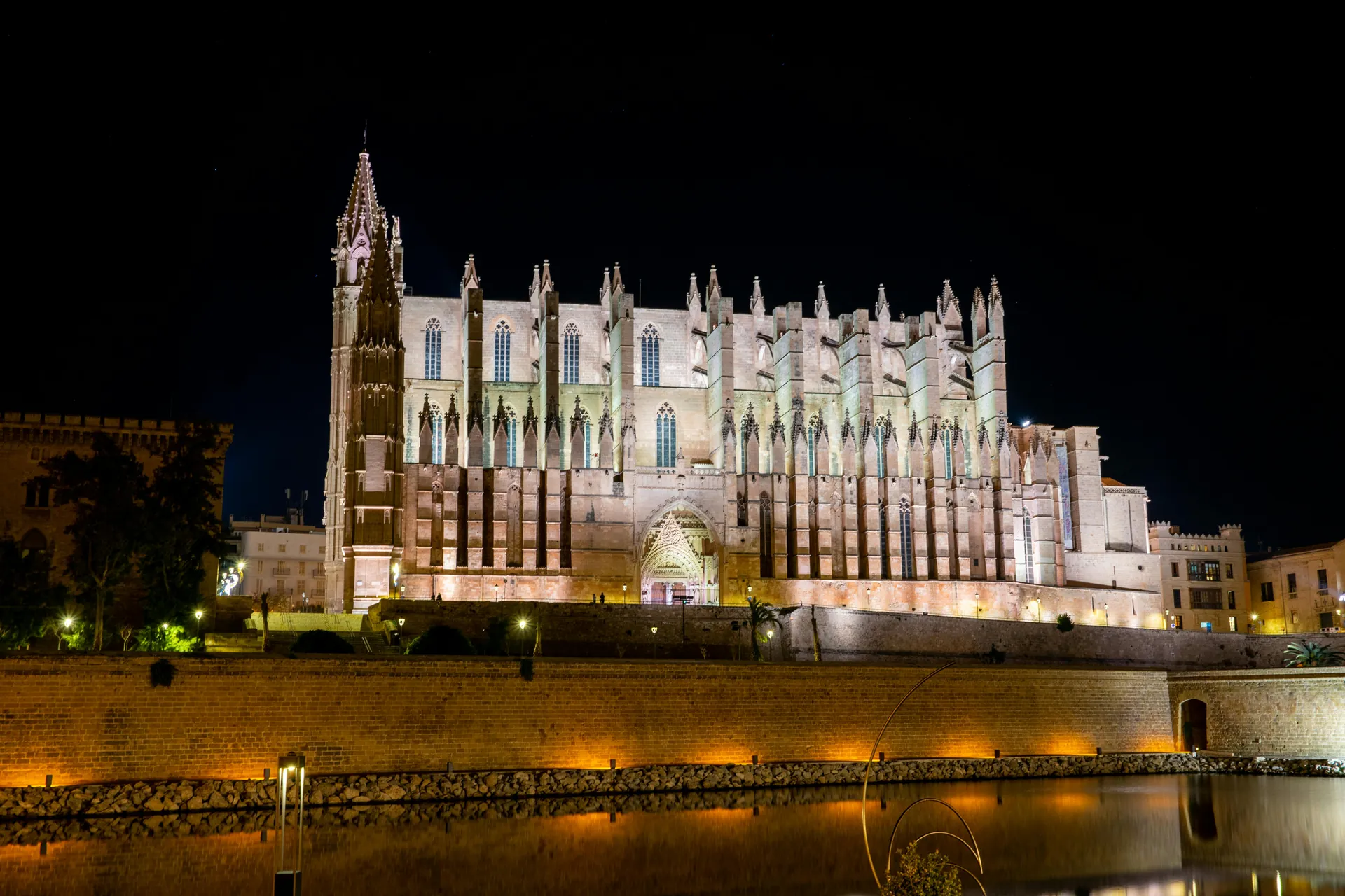 Stunning view of the illuminated Gothic Santa Maria Cathedral in Palma at night.