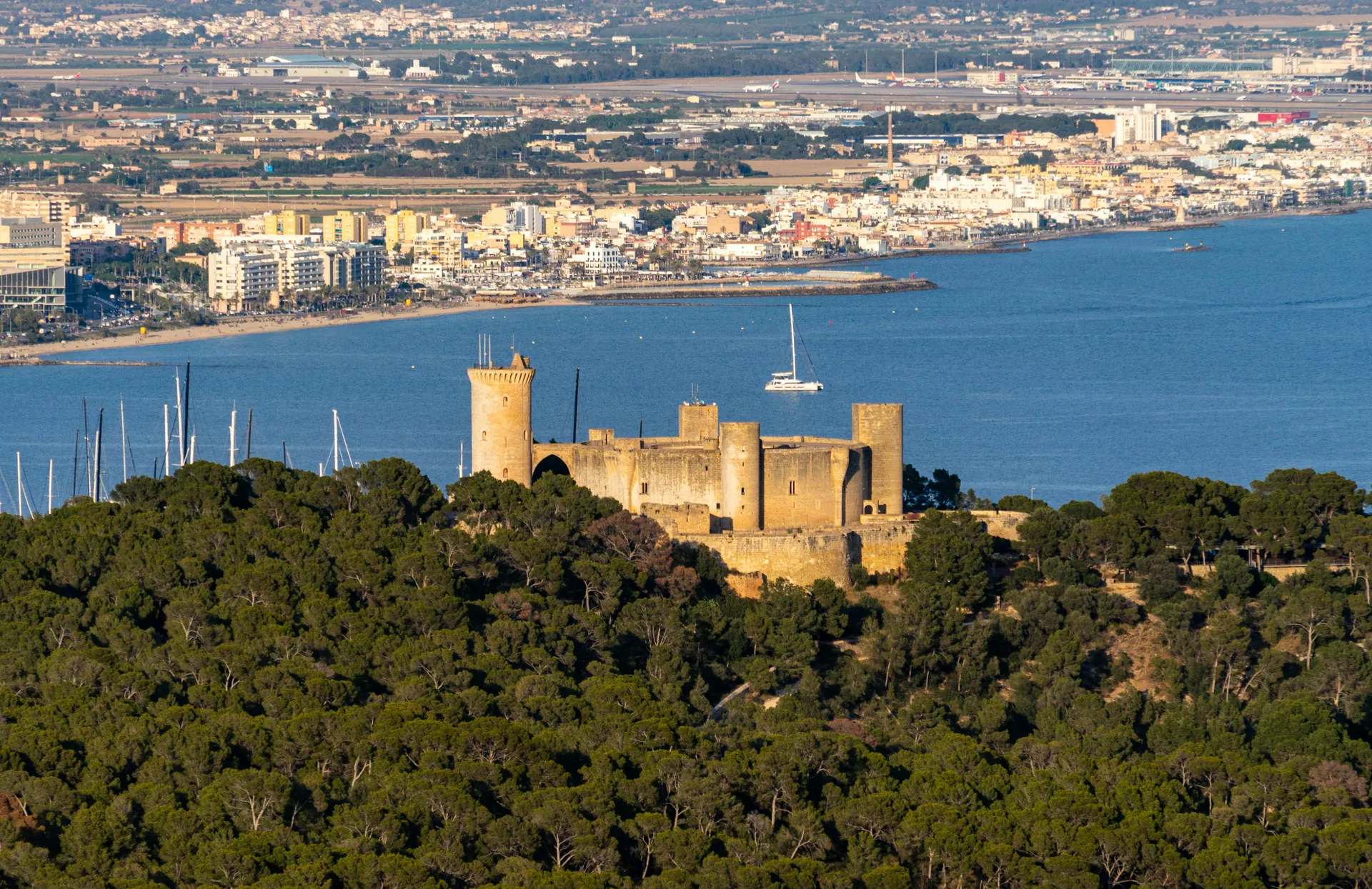 Aerial view of Bellver Castle overlooking the harbor and cityscape of Palma, Mallorca.