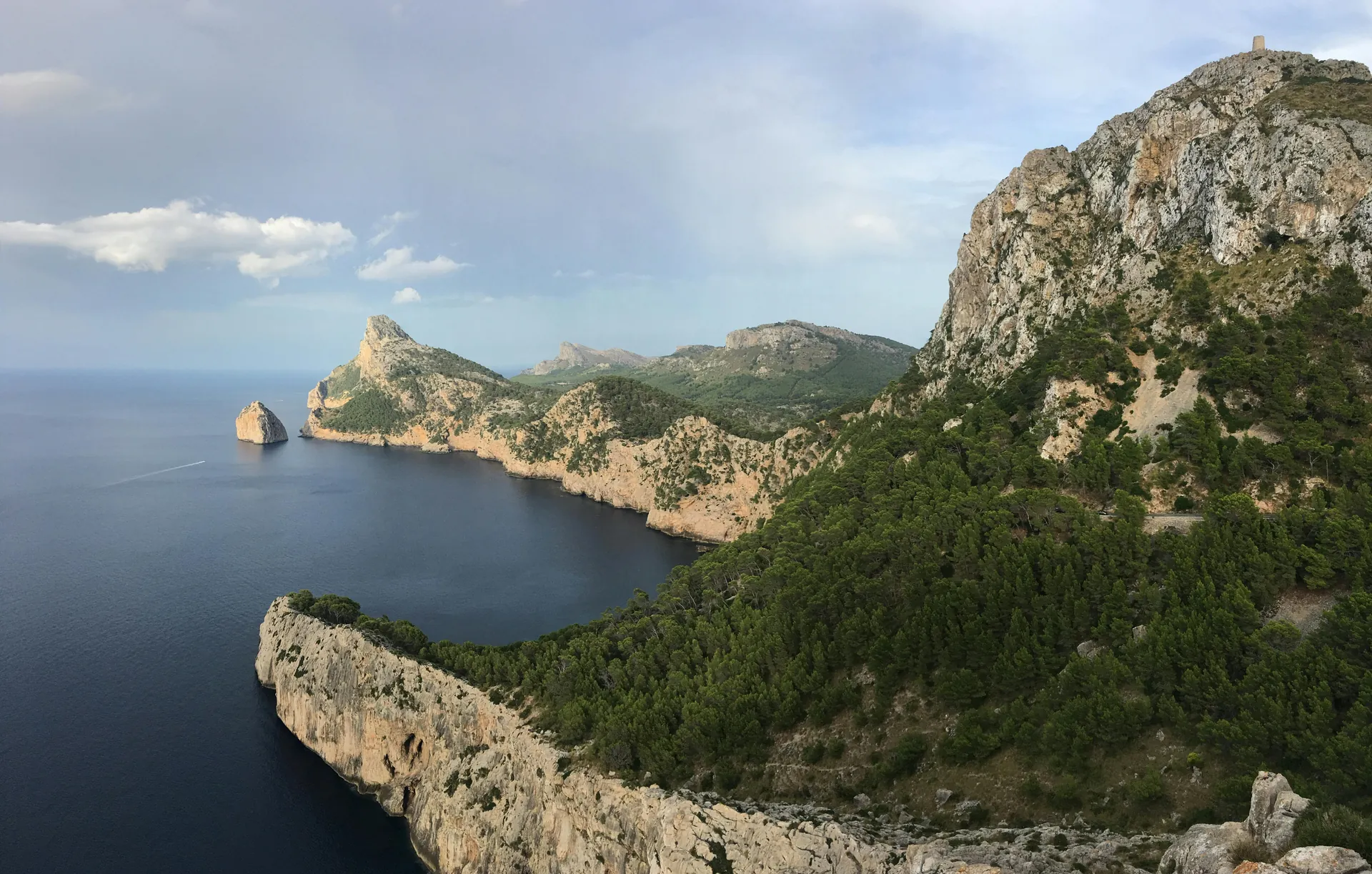 Dramatic cliffs and lush greenery along the rugged coast of Mallorca, Spain.